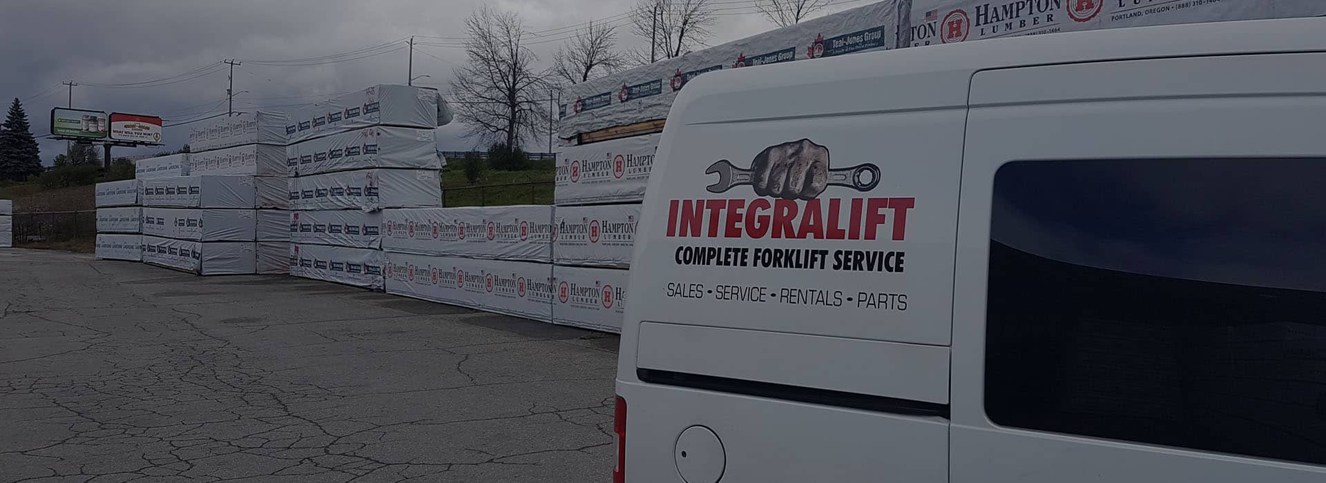 Integralift Sales And Services Inc. service van at a lumber yard